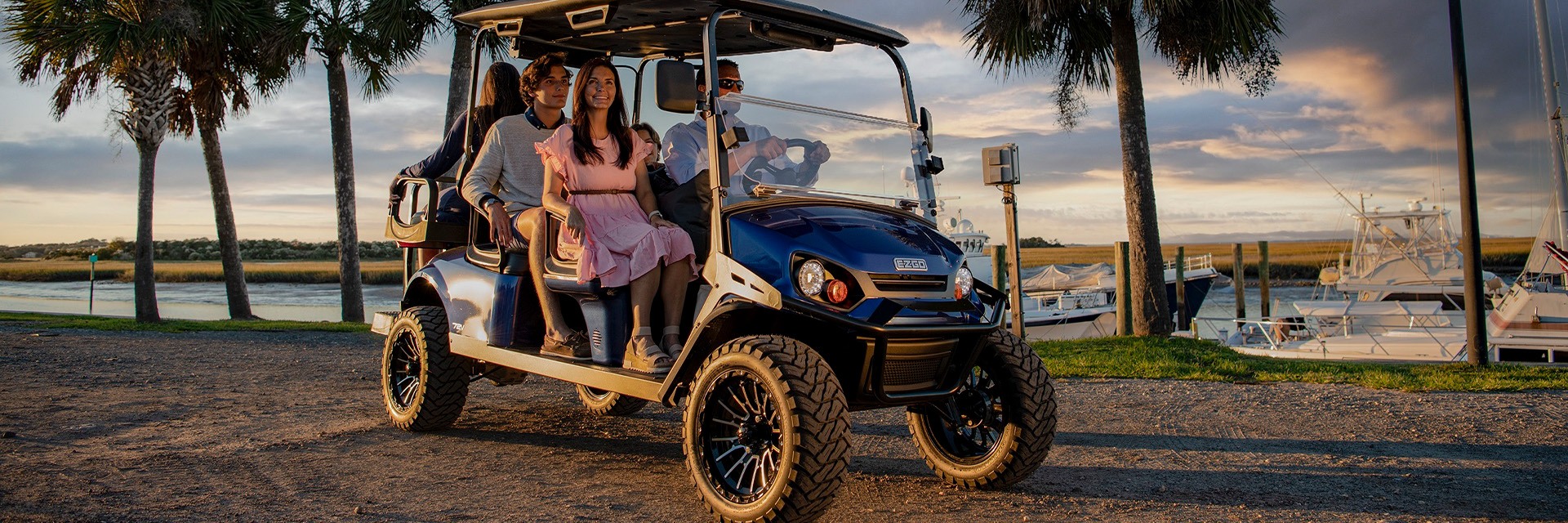 group of people riding on a E-Z-Go 6-passenger golf cart